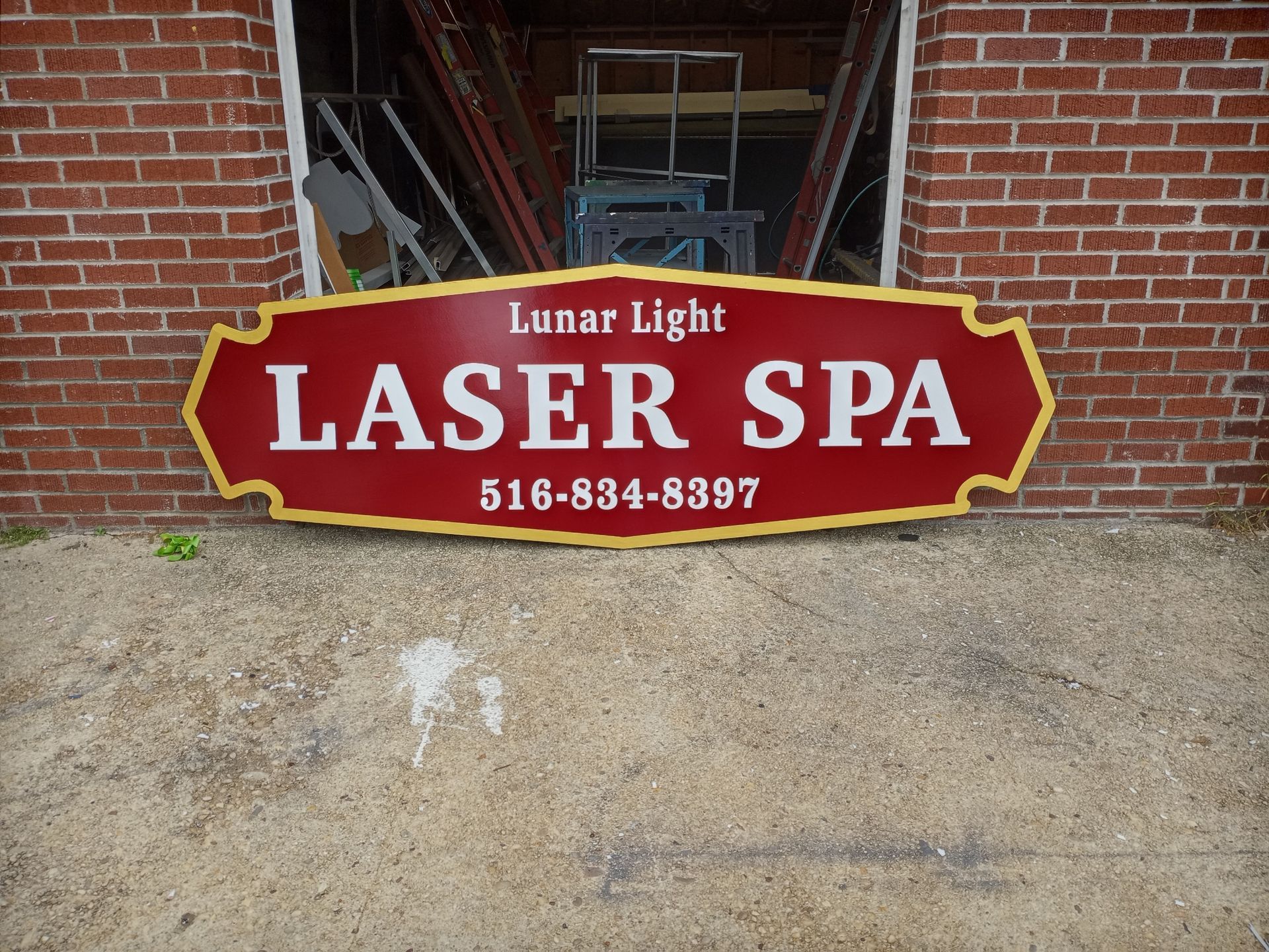A red wood sign that says laser spa on it