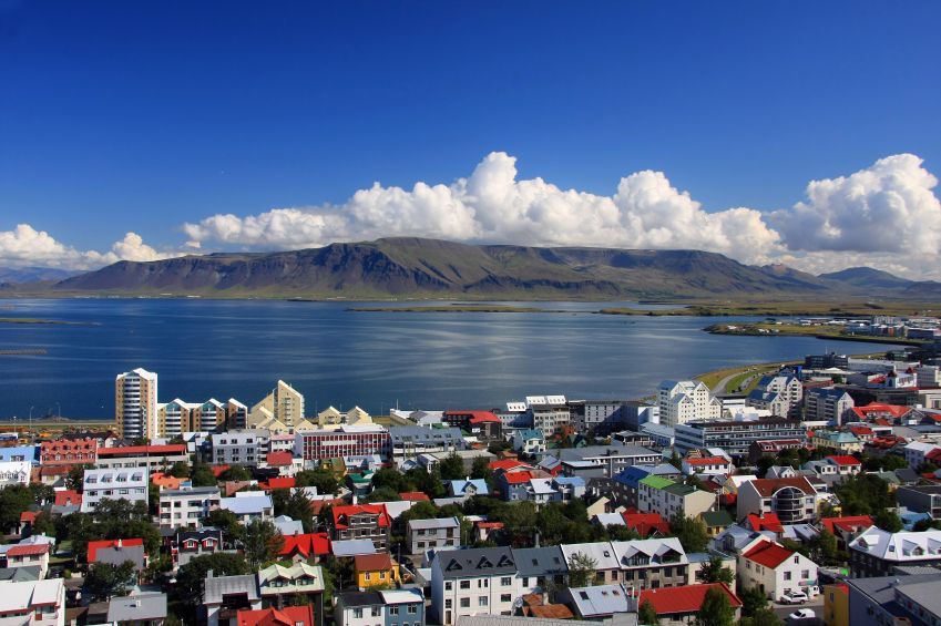 An aerial view of a city with mountains in the background