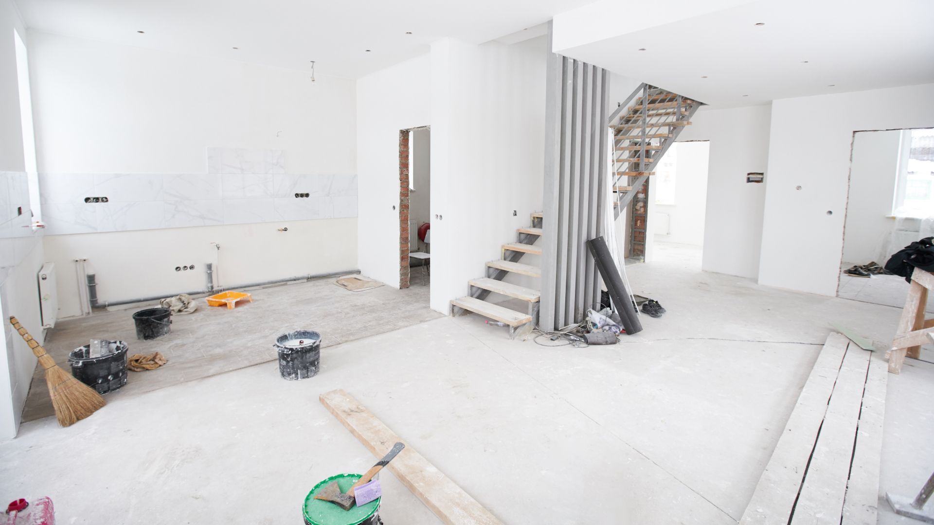 An empty room with a staircase in the middle of it.