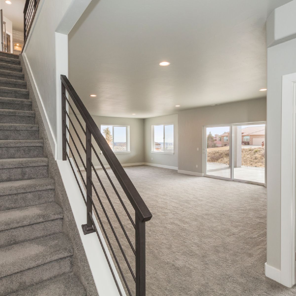 An empty house with stairs leading up to the second floor