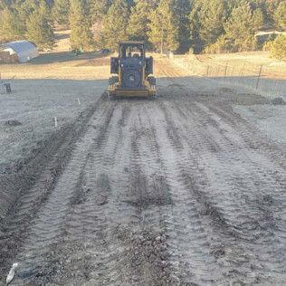 Bulldozer Driving Down Dirt Road - Elizabeth, CO – NRK Skidsteer
