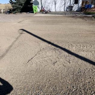 Shadow of Pole Cast on Gravel Road - Elizabeth, CO – NRK Skidsteer