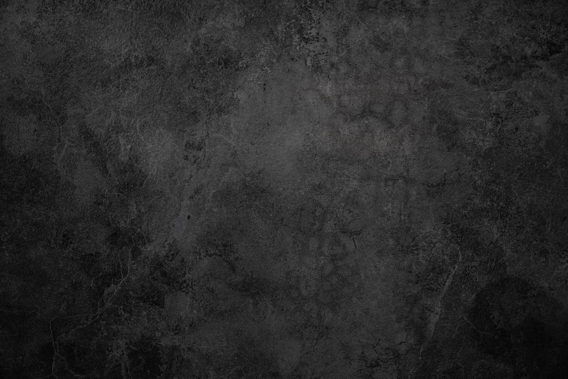 Dark gray concrete wall with rough texture.