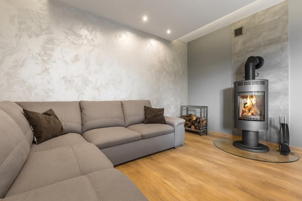 A Living Room With A Couch And A Fireplace — Donnelly Painting In Wollongbar, NSW