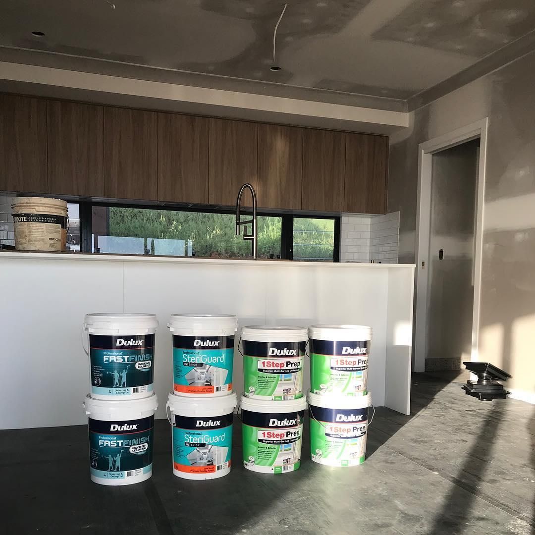 Buckets Of Paint Are Sitting On The Floor In A Kitchen — Donnelly Painting In Wollongbar, NSW