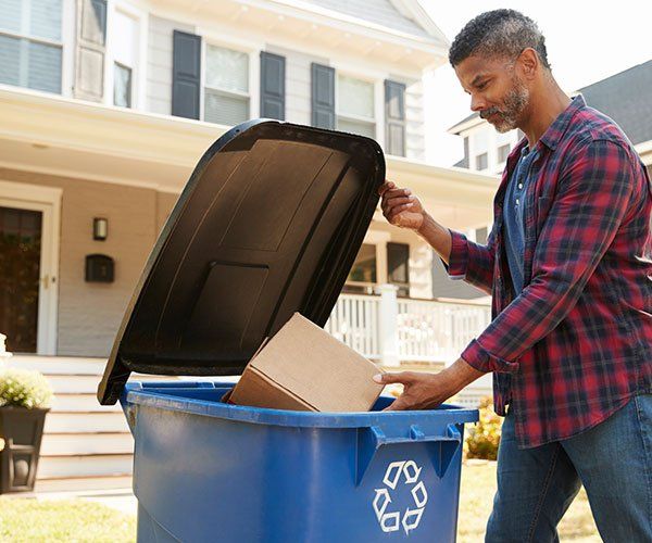 Man Throwing Trash — Storm Lake, IA — Garbage Hauling Service Inc