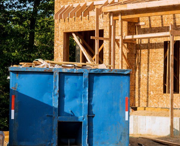 Dumpster Truck On Construction Site — Storm Lake, IA — Garbage Hauling Service Inc