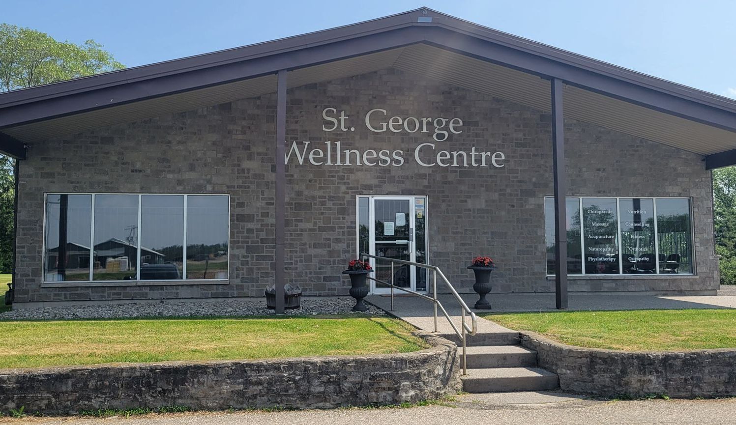 A large brick building with the words st. george wellness centre on it