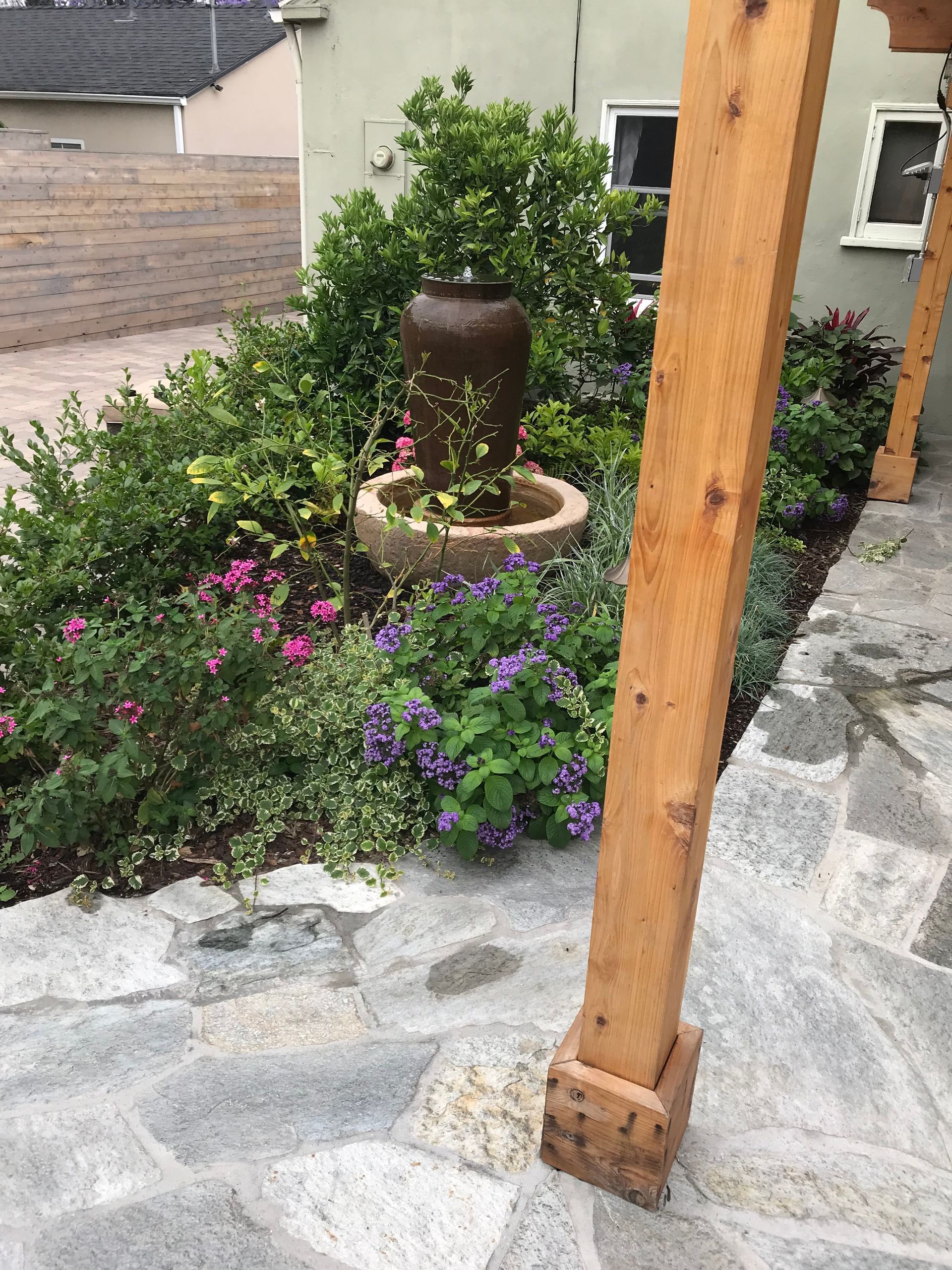 There is a fountain in the middle of the garden.