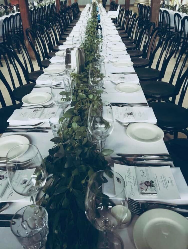 A Long Table With Plates and Glasses on It — Hello Poppy Lane Florist In Wodonga, VIC