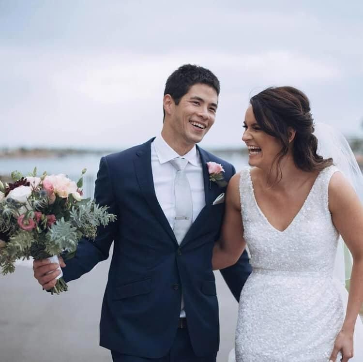 A Bride and Groom Are Standing Next to Each Other Holding a Bouquet of Flowers — Hello Poppy Lane Florist In Wodonga, VIC