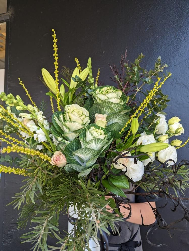 A Person is Holding a Bouquet of Flowers in a Vase — Hello Poppy Lane Florist In Wodonga, VIC