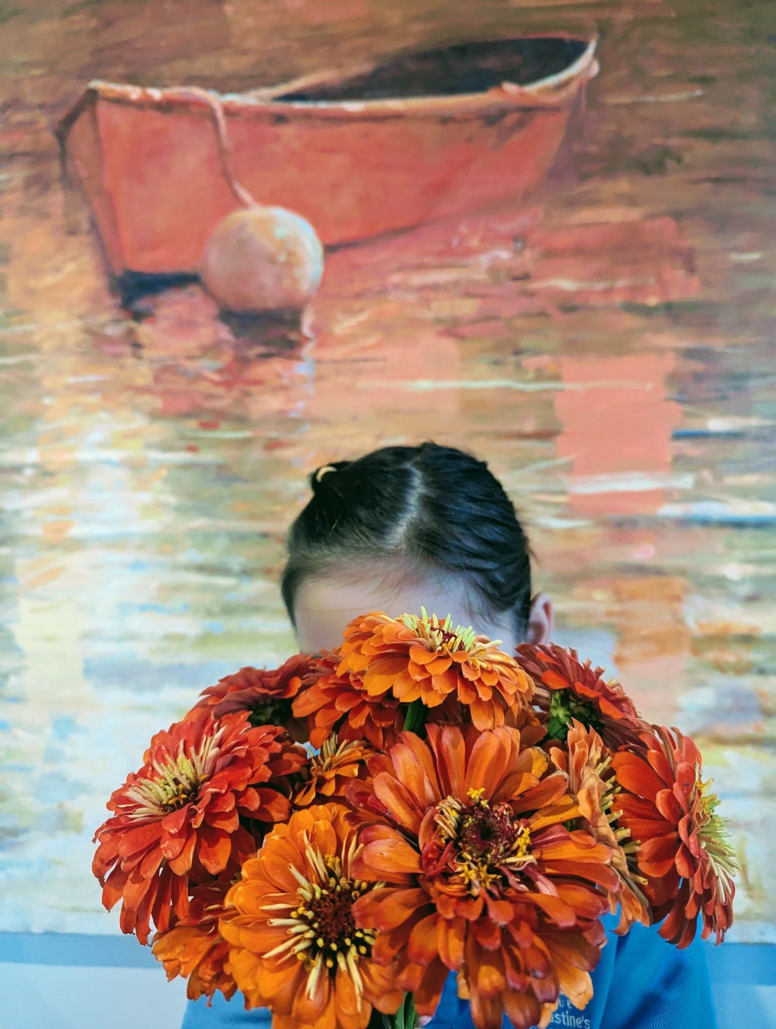A Girl Covering Her Face With Flowers in Front of a Painting of a Boat — Hello Poppy Lane Florist In Albury, NSW