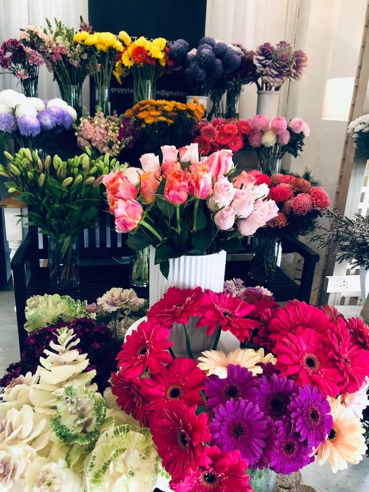 A Bunch of Flowers Are Sitting on a Table in a Room — Hello Poppy Lane Florist In Ebden, VIC