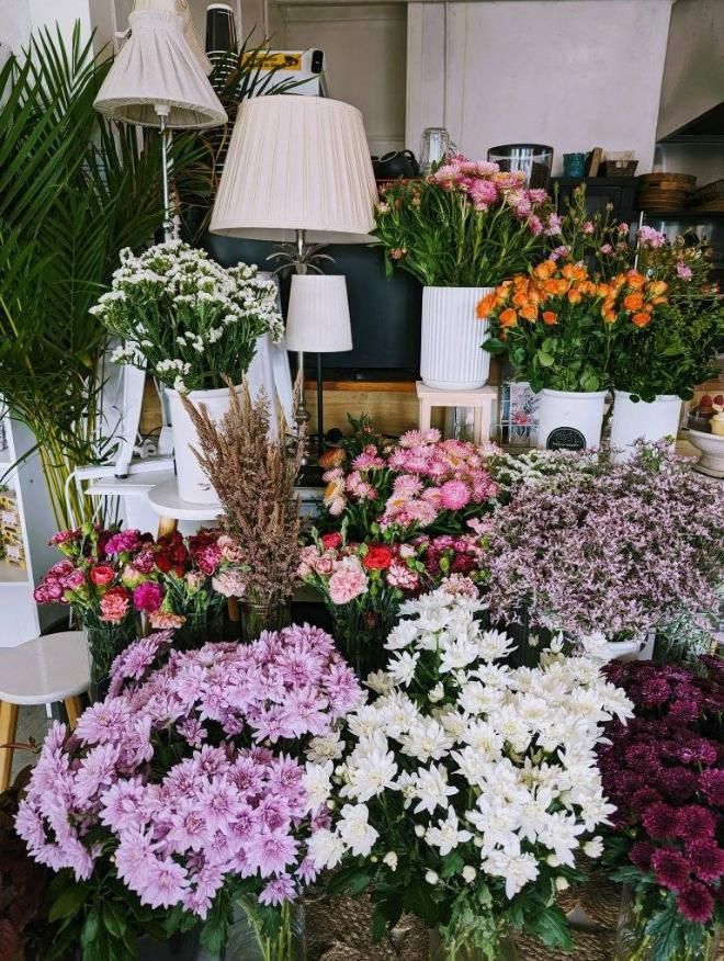 A Bouquet of Pink and Purple Flowers on a Wooden Table — Hello Poppy Lane Florist In Wodonga, VIC