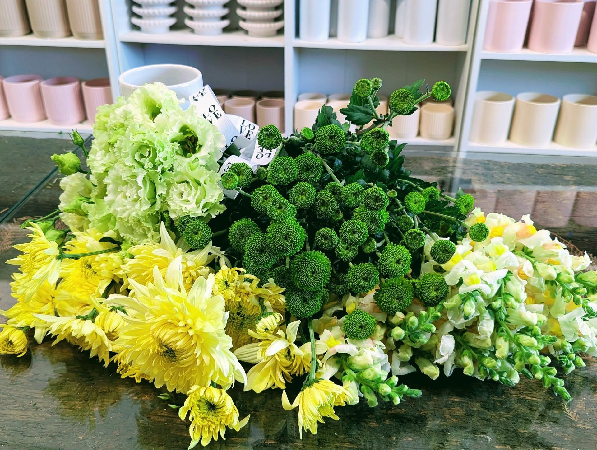 A Bunch of Yellow and Green Flowers Are Sitting on a Table — Hello Poppy Lane Florist In Albury, VIC