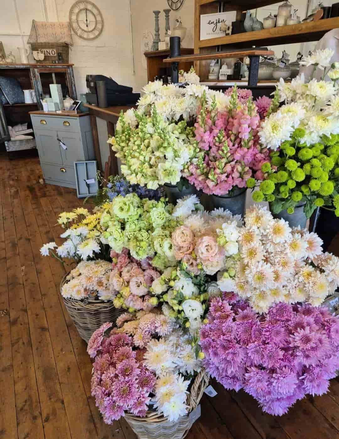 A Bunch of Flowers Are Sitting on a Wooden Floor in a Store — Hello Poppy Lane Florist In Rutherglen, NSW