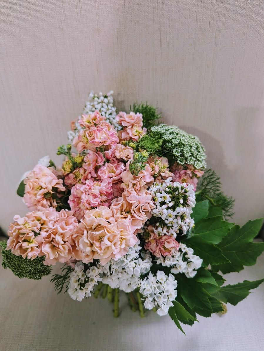 A Bouquet of Pink and White Flowers is Sitting on a Table — Hello Poppy Lane Florist In Wodonga, VIC