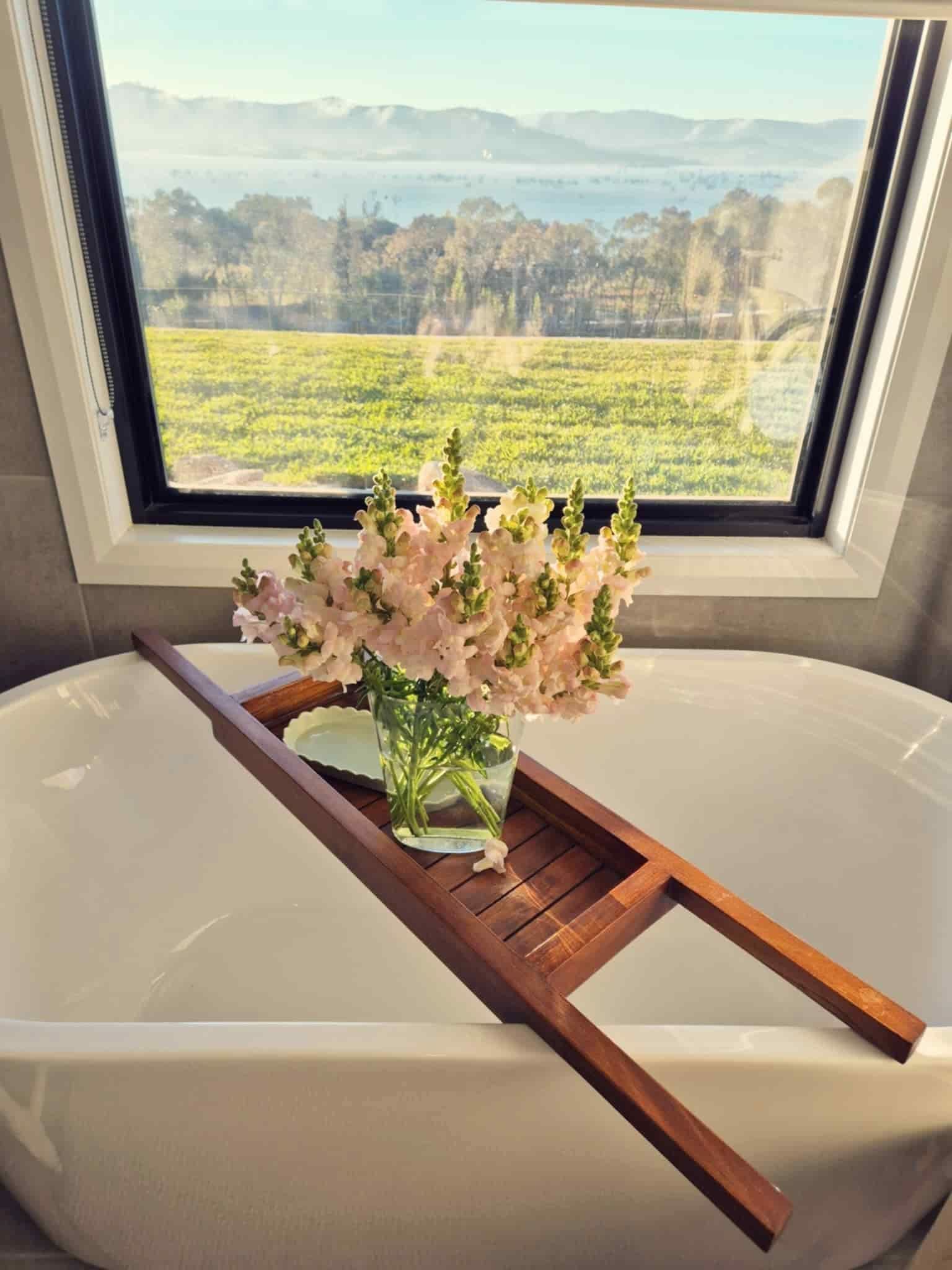A Bathtub With a Wooden Bathtub Tray and a Vase of Flowers on It — Hello Poppy Lane Florist In Rutherglen, NSW