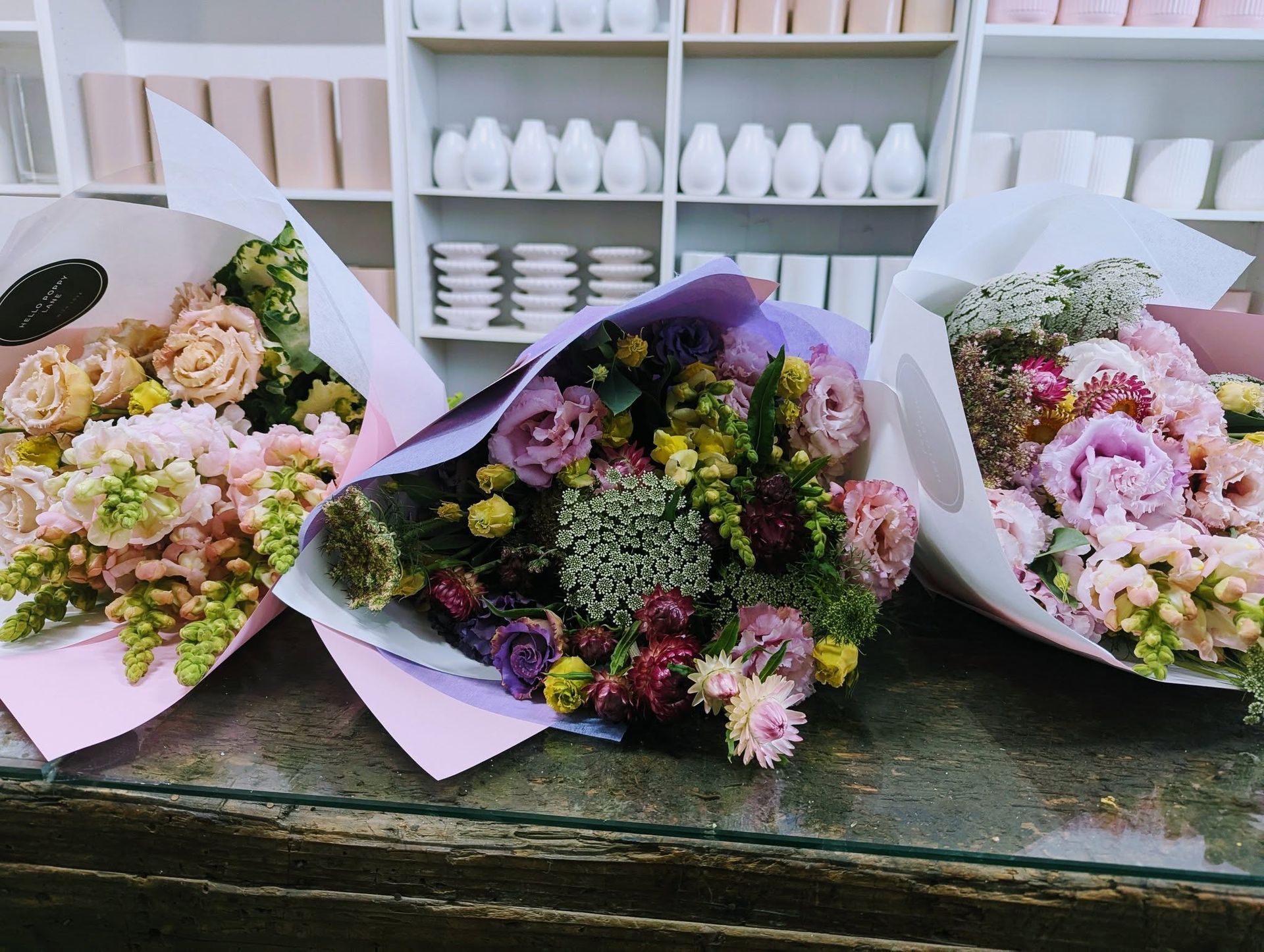 Three Bouquets of Flowers Are Sitting on a Glass Table — Hello Poppy Lane Florist In Albury, NSW