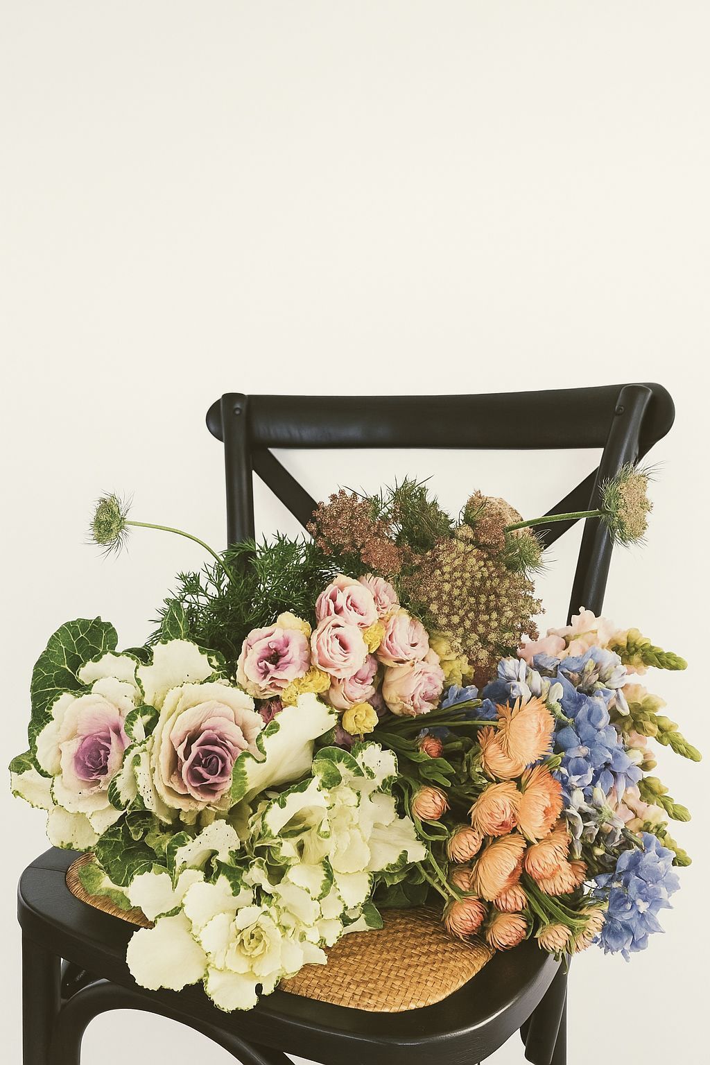 A Black Chair With a Bouquet of Flowers on It — Hello Poppy Lane Florist In Albury, NSW