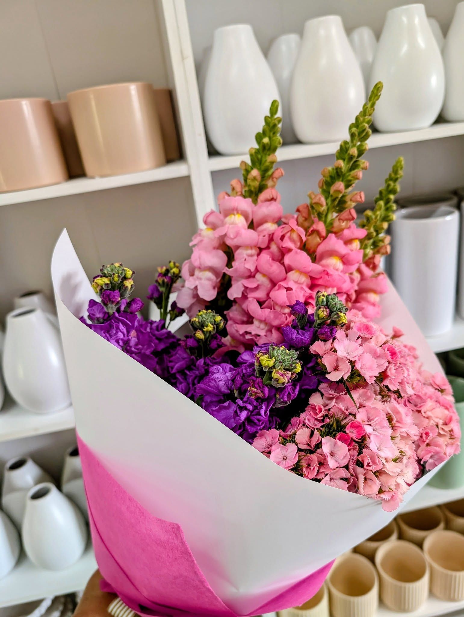 Bouquet of Colorful Snapdragons in Pink, Purple, and Peach Tones, Wrapped in White and Pink Paper — Hello Poppy Lane Florist In Albury, NSW