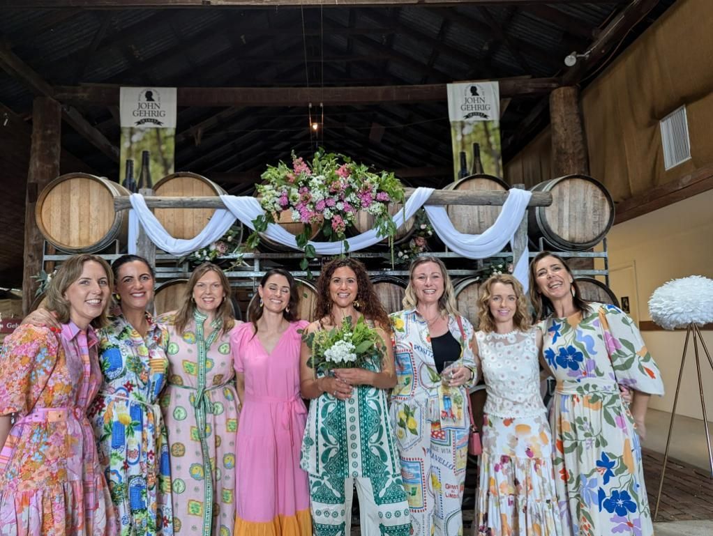 A Group of Women Are Posing for a Picture in Front of Barrels — Hello Poppy Lane Florist In Wodonga, VIC