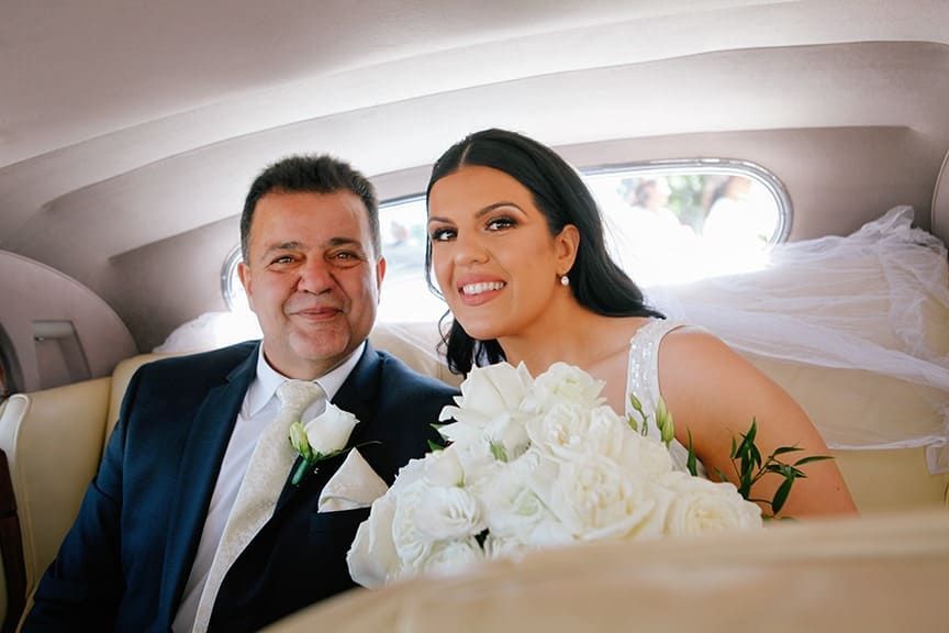 A Bride And Groom Are Sitting In The Back Seat Of A Car — Hello Poppy Lane Florist In Albury, NSW