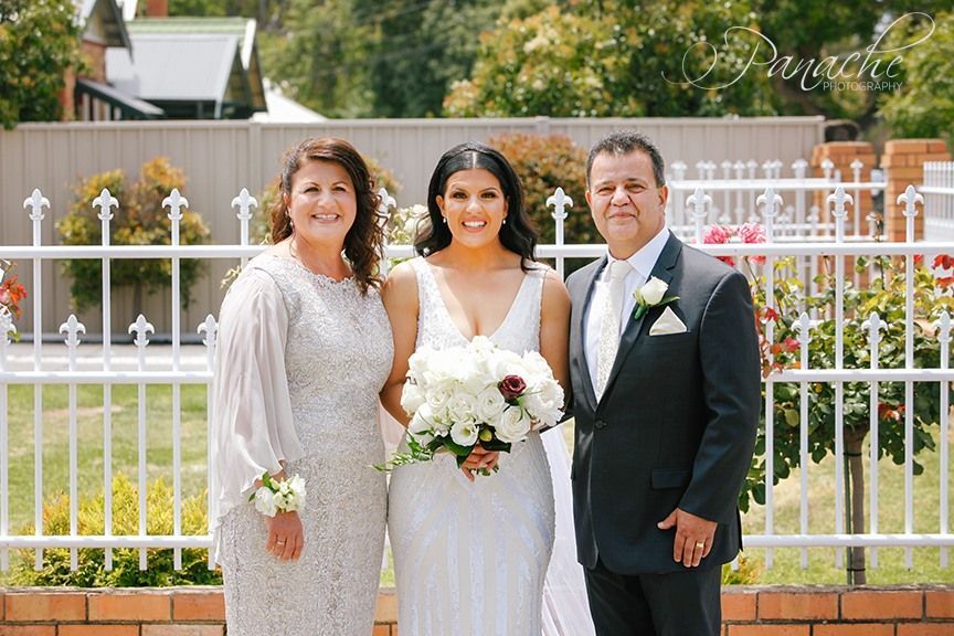 The Bride and Groom Are Posing for a Picture With Their Parents — Hello Poppy Lane Florist in Rutherglen, NSW