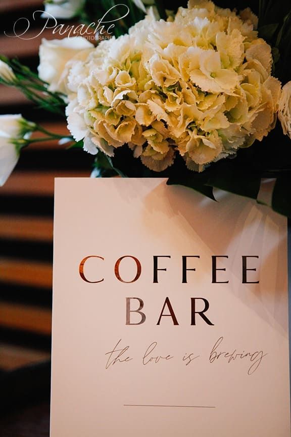 A Coffee Bar Sign With White Flowers In The Background — Clover Country Flowers and Gifts In Highfields, QLD