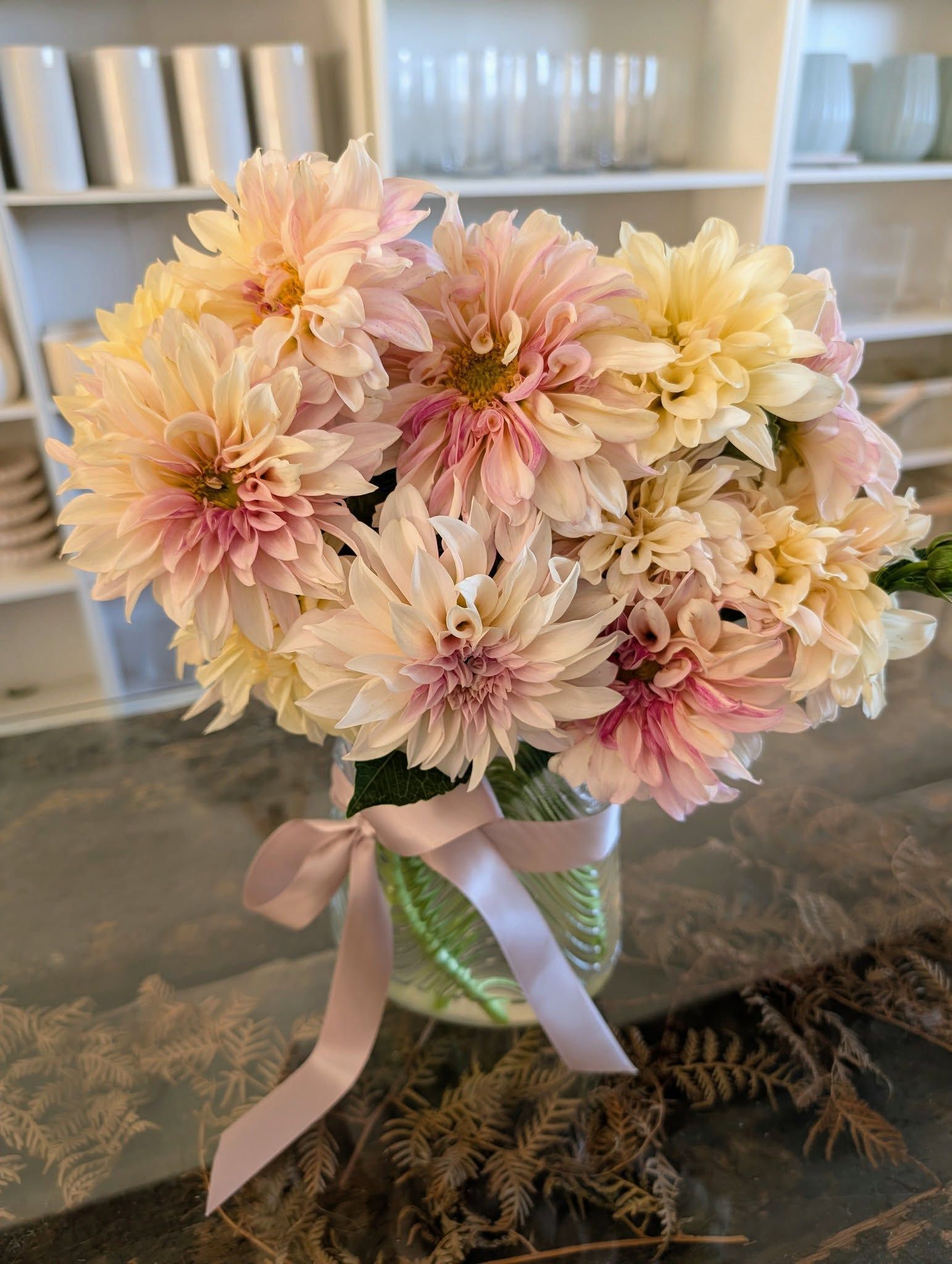Bouquet of pale pink and yellow dahlias in a glass jar, tied with a pink ribbon — Hello Poppy Lane Florist In Albury, NSW