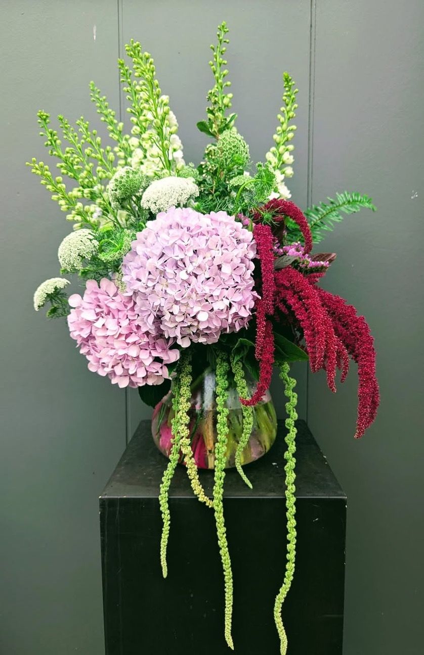 A Vase Filled With Pink and White Flowers is Sitting on a Table — Hello Poppy Lane Florist in Albury, NSW