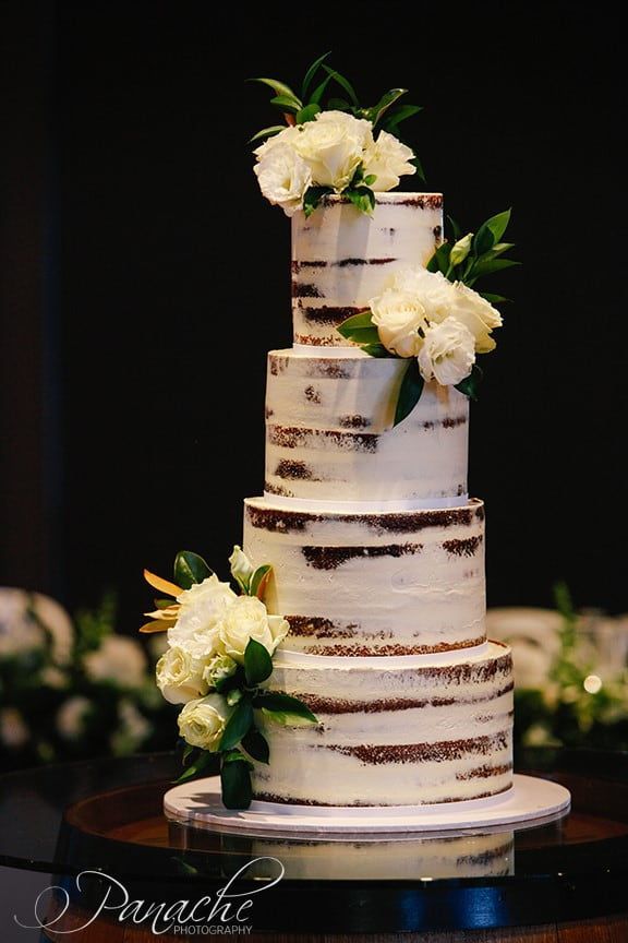 A Wedding Cake with White Flowers on Top of It Is on A Table — Hello Poppy Lane Florist In Ebden, VIC