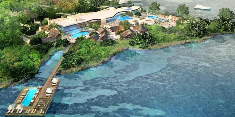 Eine Luftaufnahme eines Resorts auf einer kleinen Insel inmitten eines Gewässers.