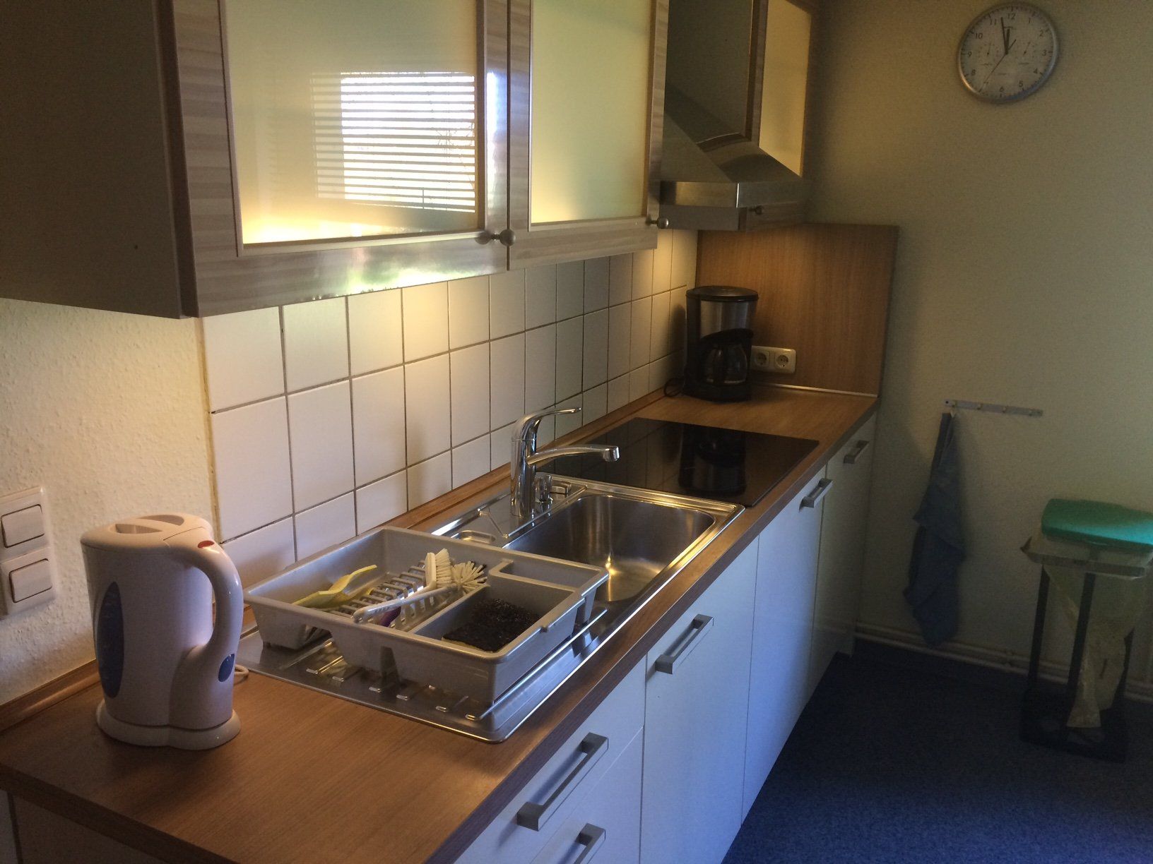 Eine Küche mit zwei Spülbecken und einer Uhr an der Wand