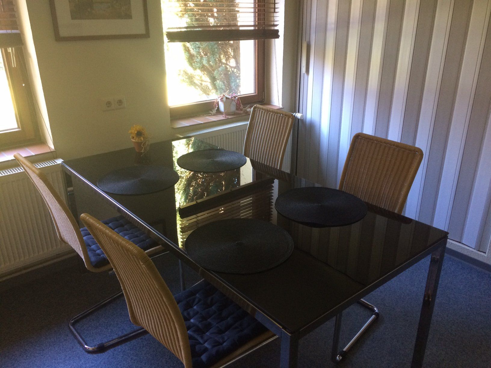 Ein Esszimmer mit Tisch und Stühlen und einem Fenster