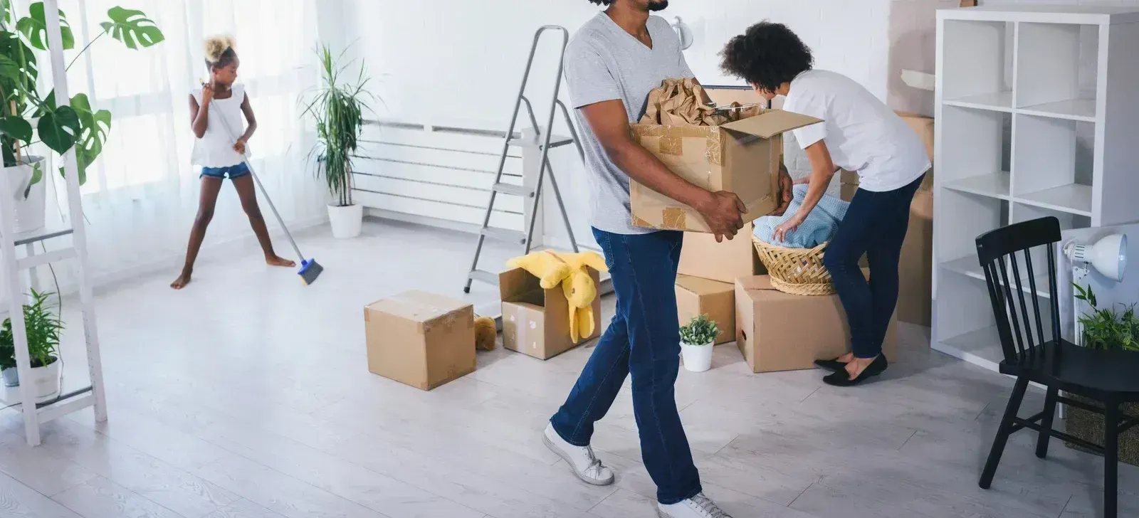 A man and a woman are moving into a new home.