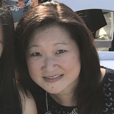 A close up of a woman 's face with a smile on her face.