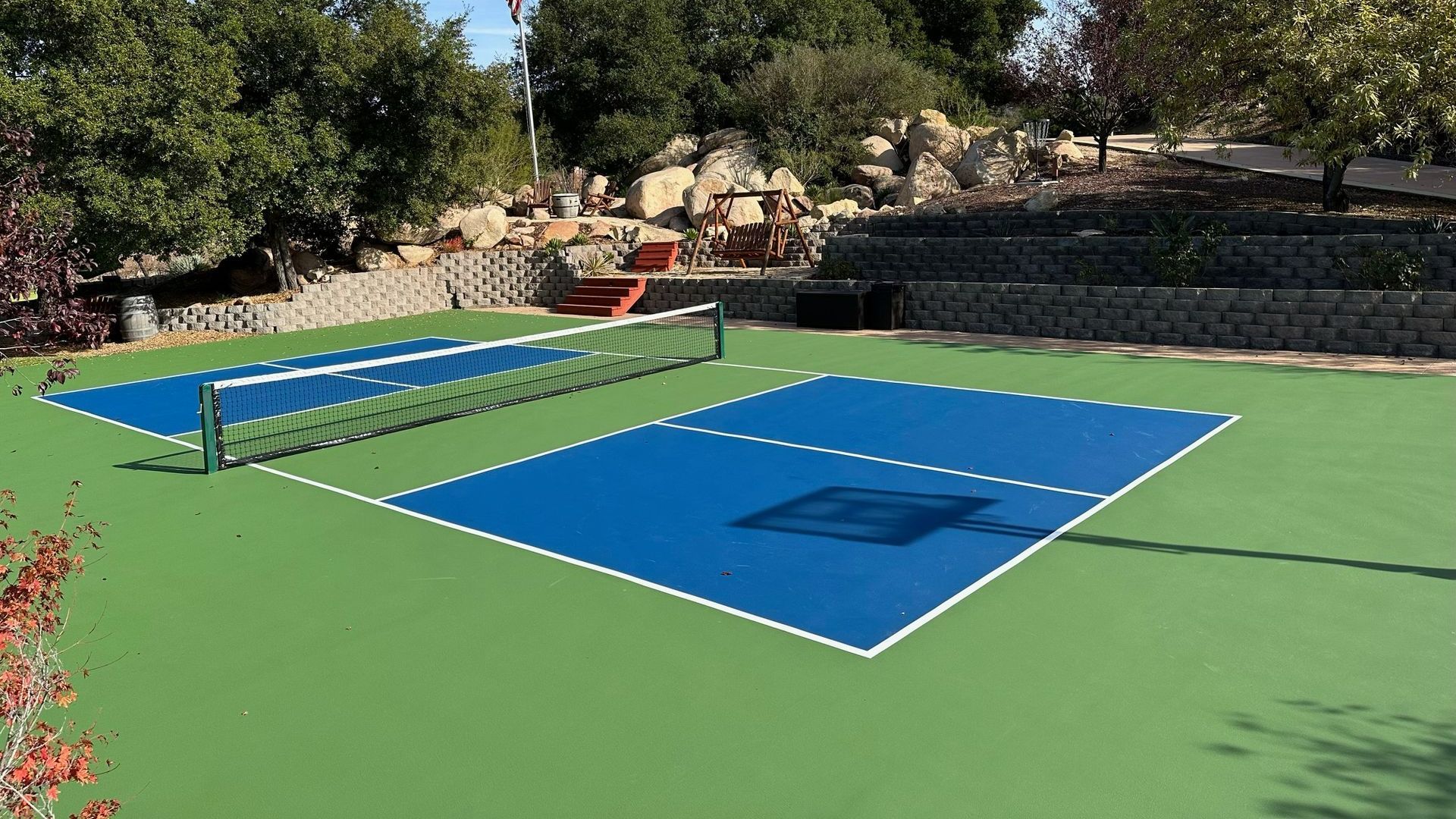 a tennis court with a blue court and a white net