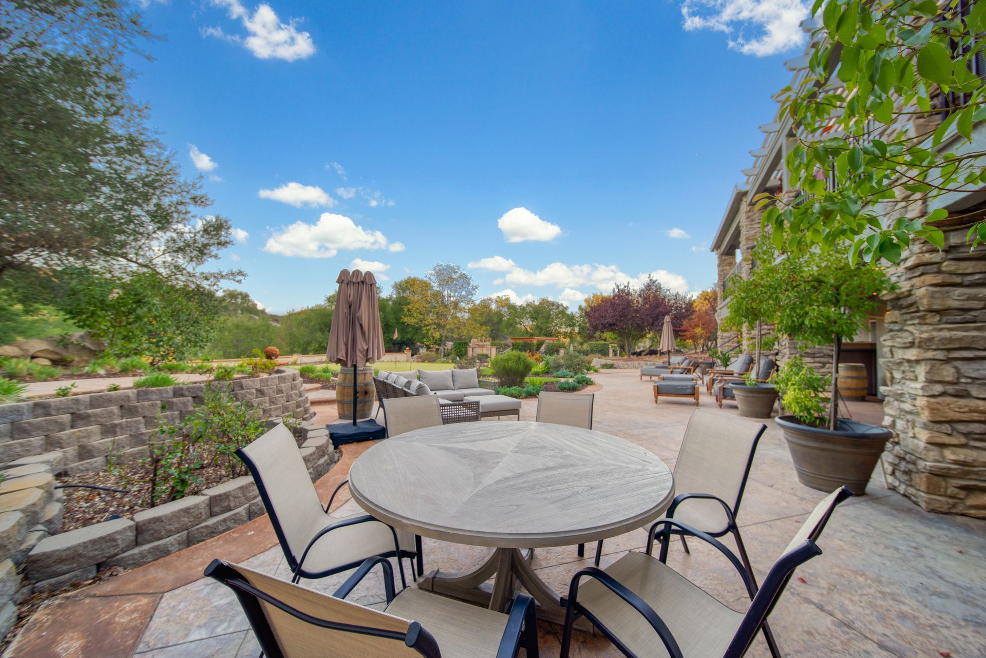 A path going through a park with trees and grass.