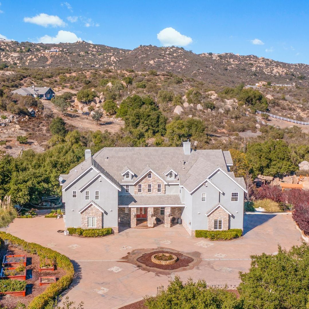 A barrel is sitting on top of a lush green field.
