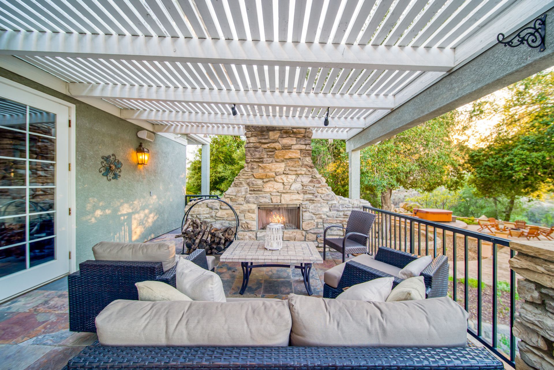 A large swimming pool surrounded by chairs and a pergola.