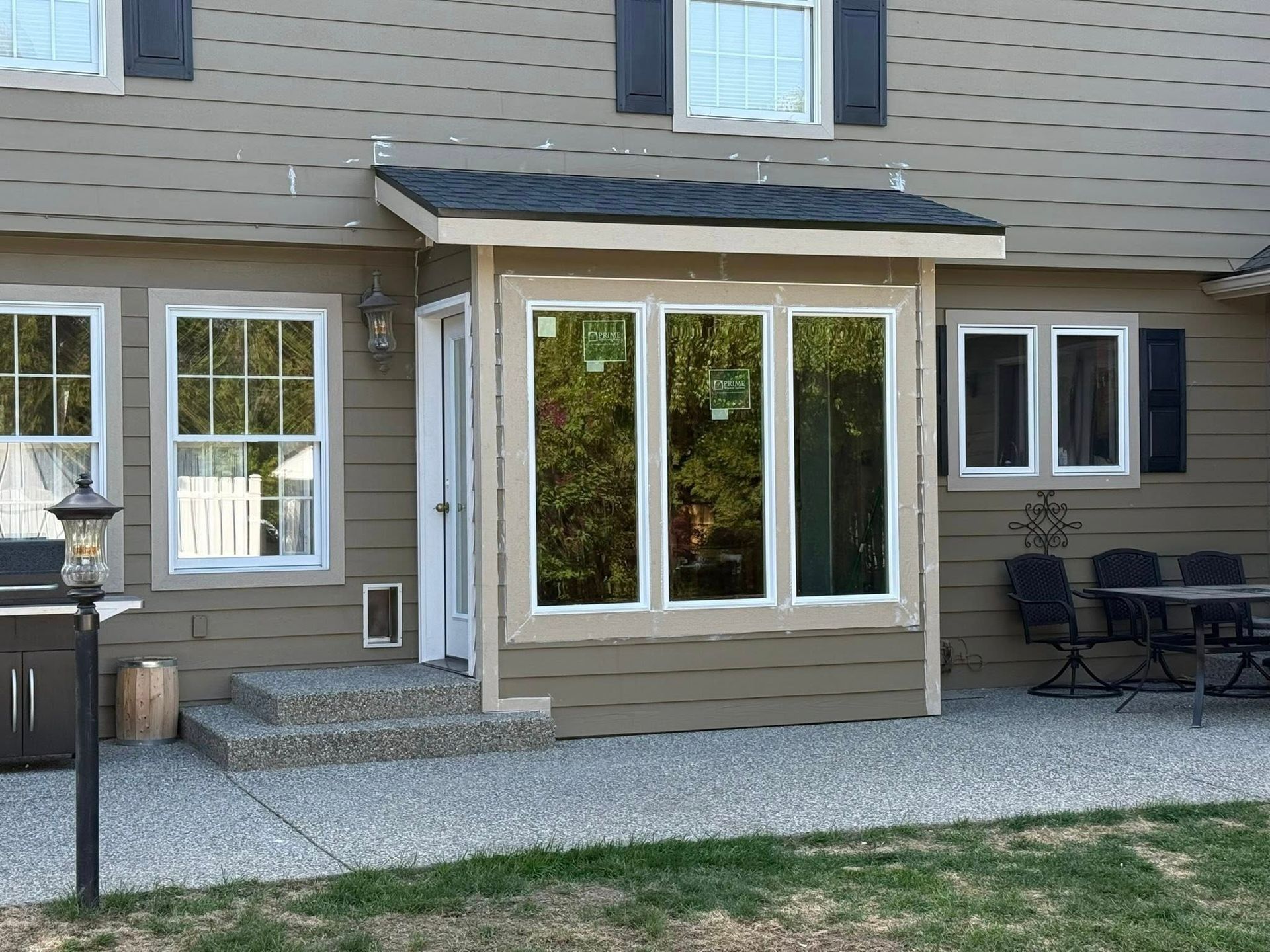 House exterior with an enclosed porch, windows, and a small step.
