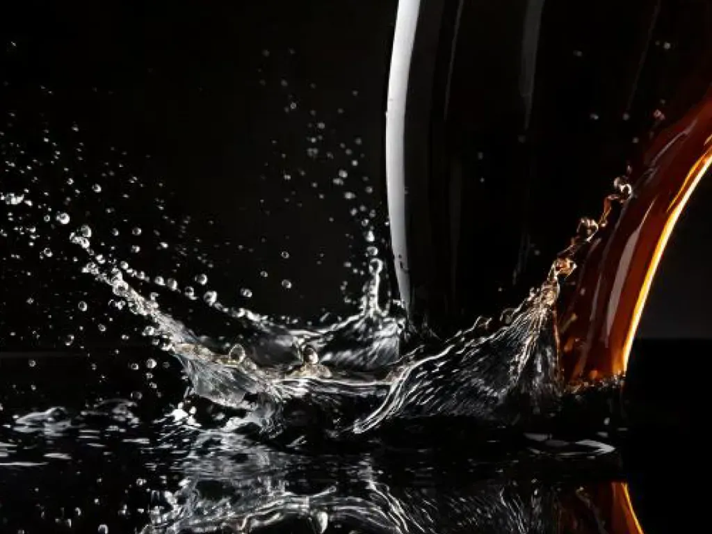 Water splashes and ripples in a dark background.