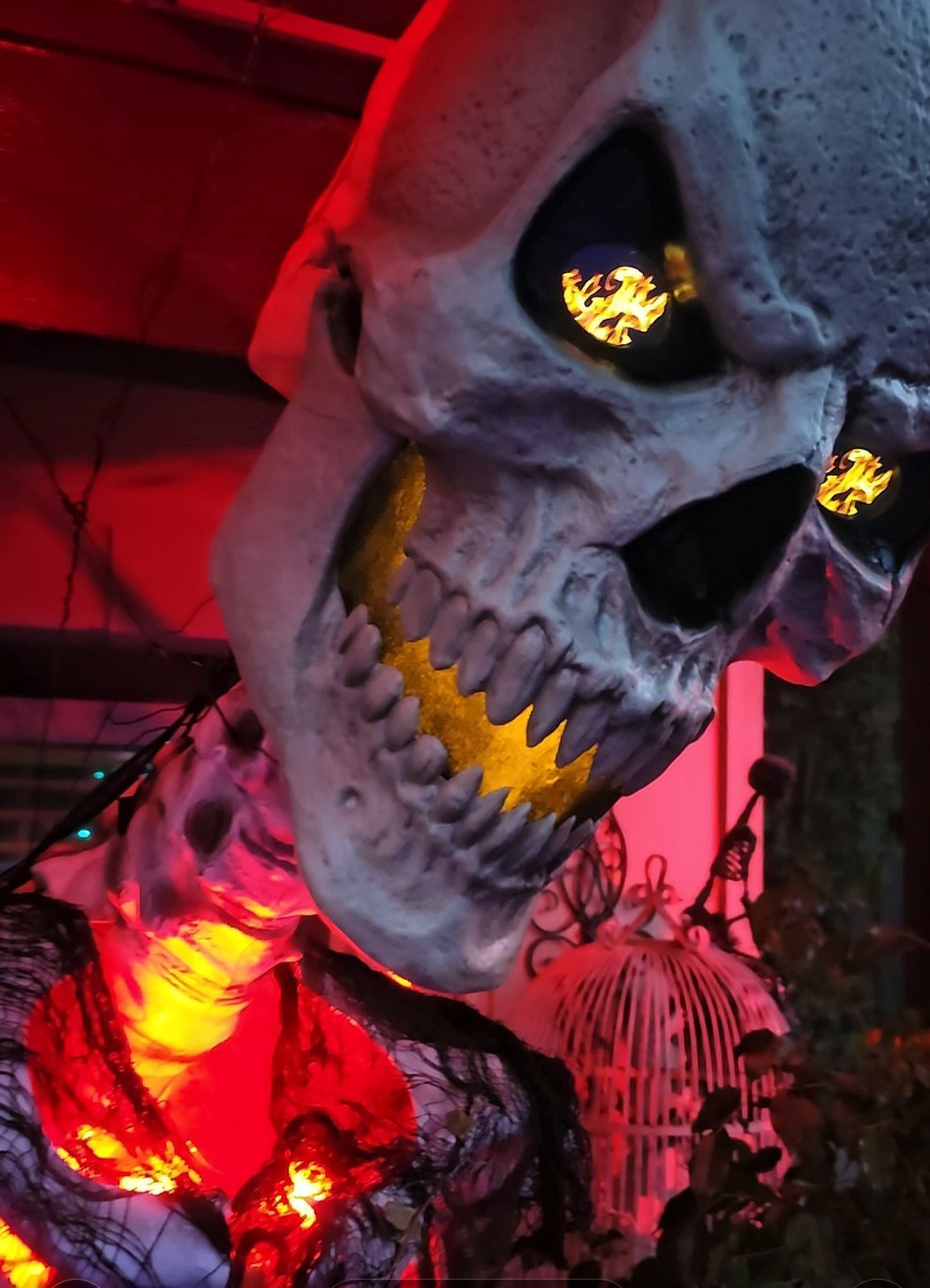 A skull with glowing eyes is hanging from the ceiling