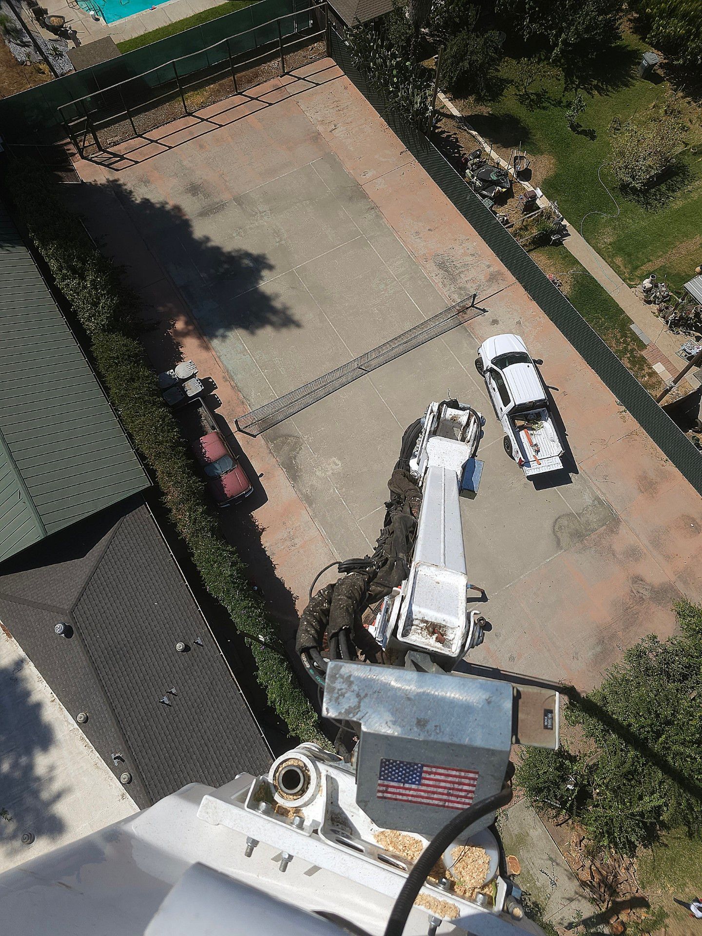 An aerial view of two trucks parked in a driveway.