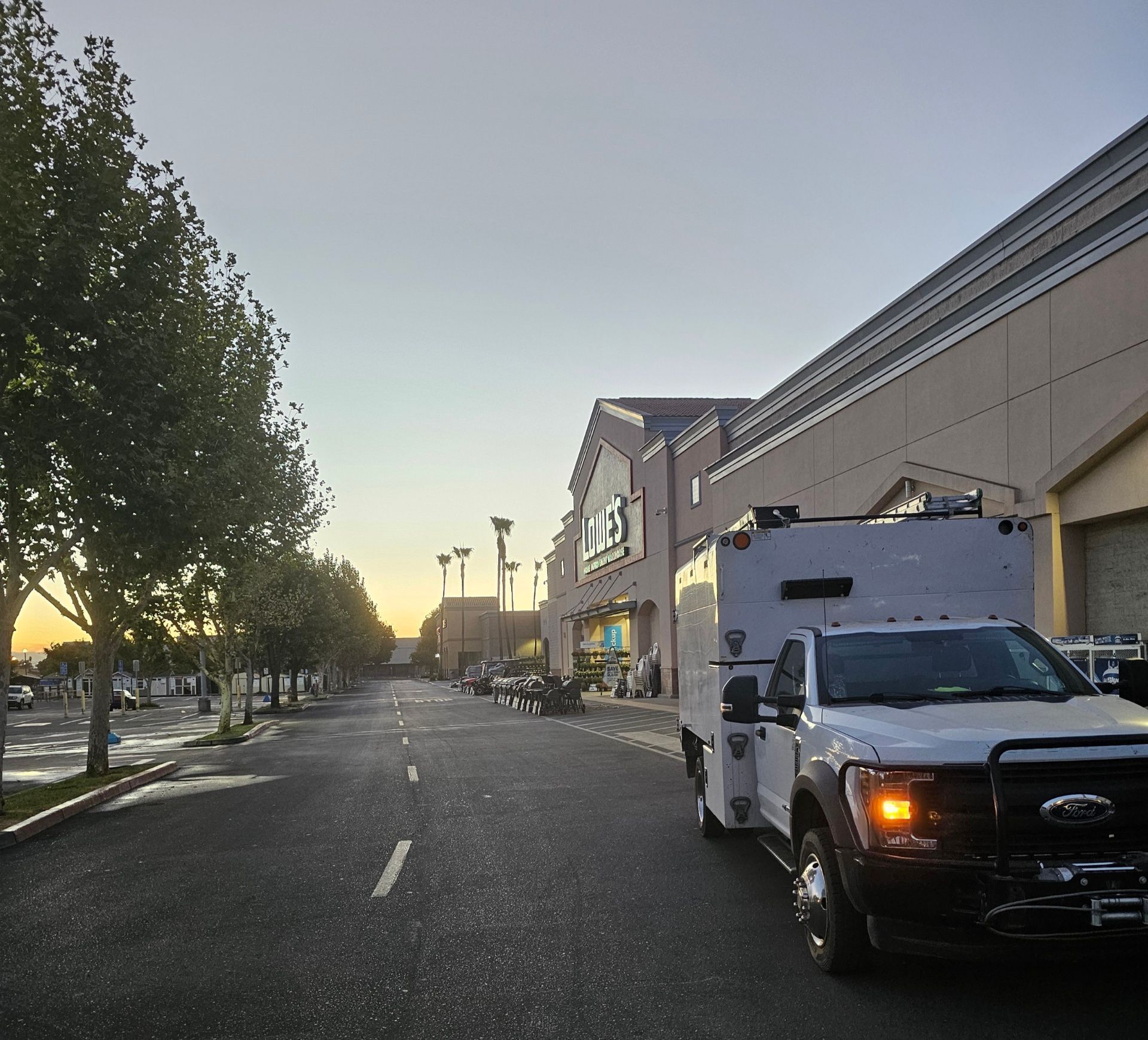 A white truck is parked in front of a store that says kmart