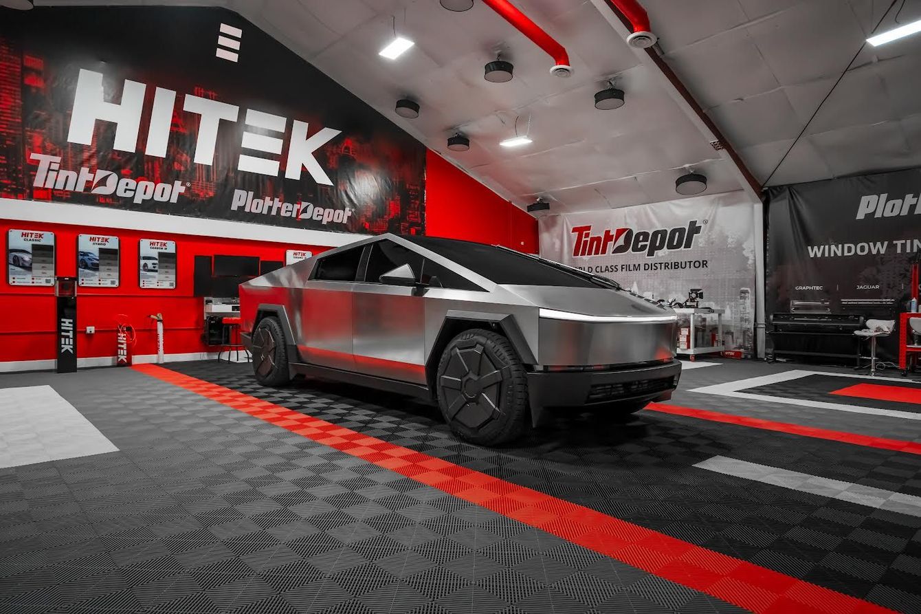 A tesla cybertruck is parked in a garage.