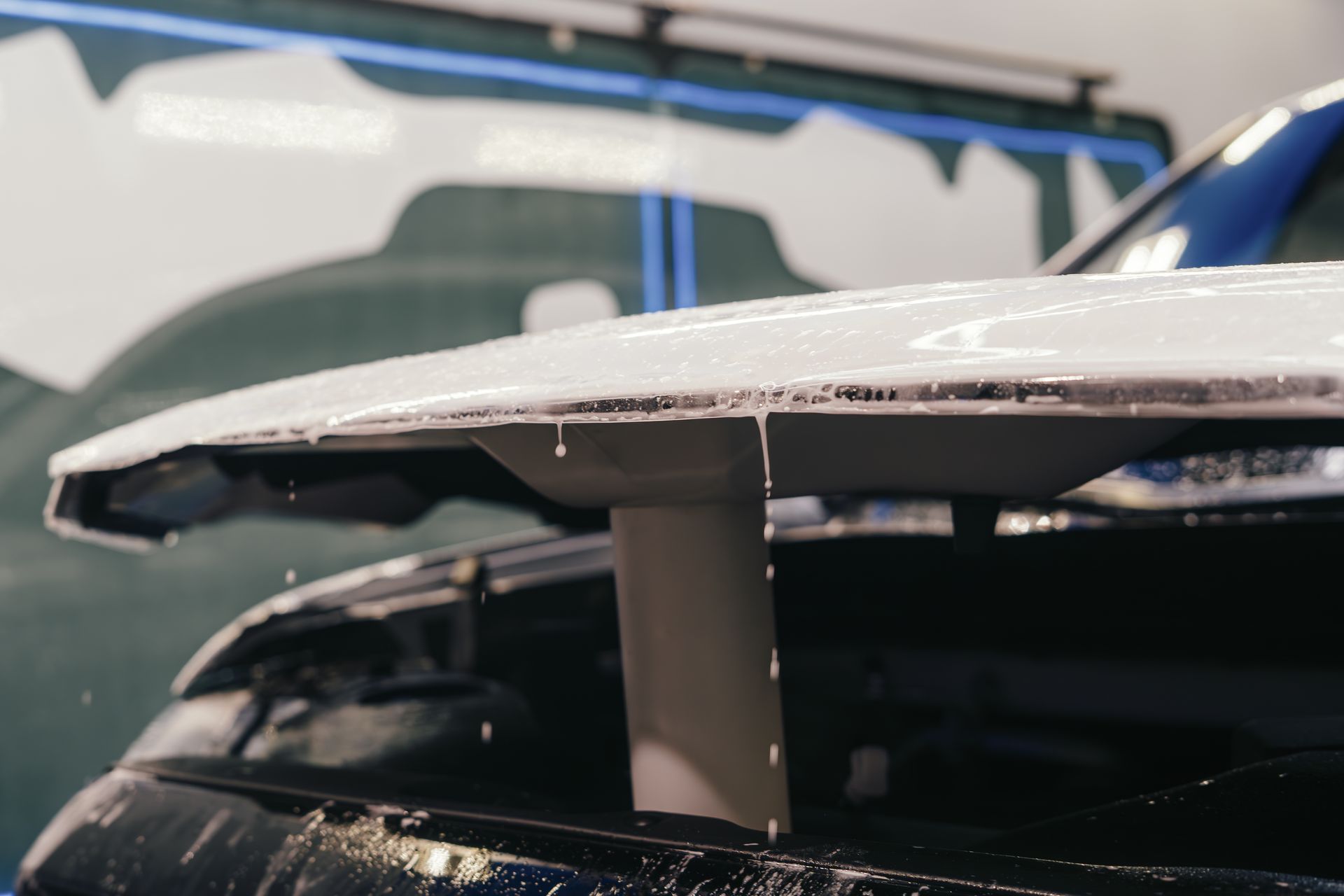 A close up of a car hood that is being repaired.