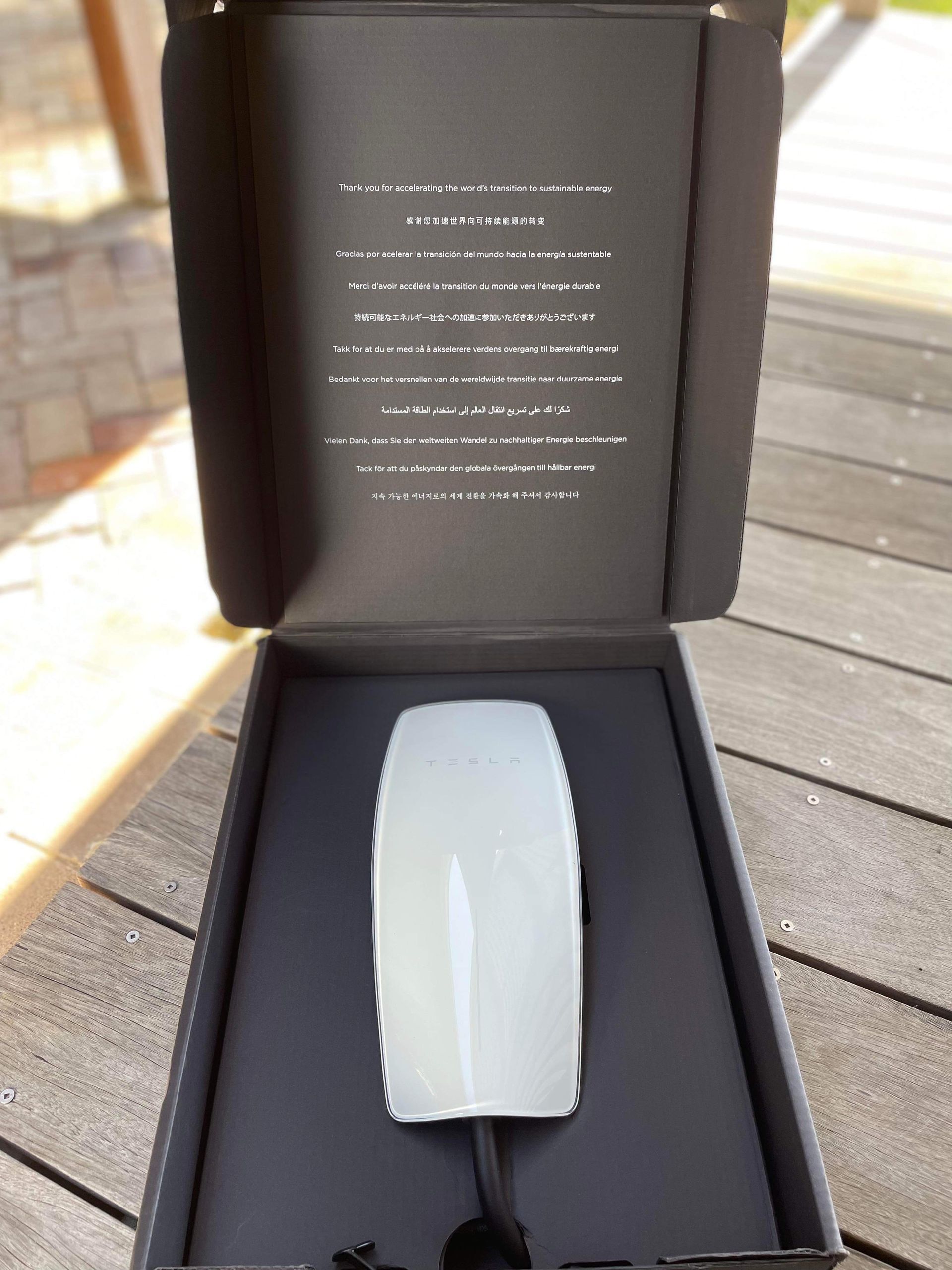 An Electric Car is Being Charged at a Charging Station — TB Electrical & Communications in Erina, NSW